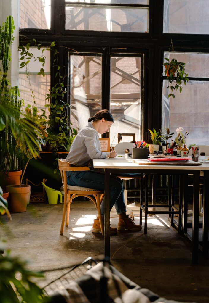 A woman works at her desk struggling to maintain work-life balance. Learn to set boundaries in Anxiety Therapy for Women in Manhattan, NY